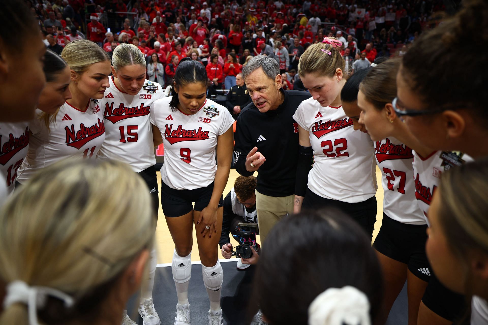 Nebraska players with their former coach John Cook (Image via: Getty)